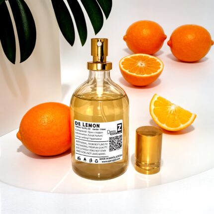 a bottle of perfume next to oranges
