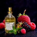 Elegant glass bottle of mixed berry perfume with vibrant notes of fresh strawberries, blueberries, raspberries, and blackberries, exuding a fruity and refreshing aroma, perfect for daily wear